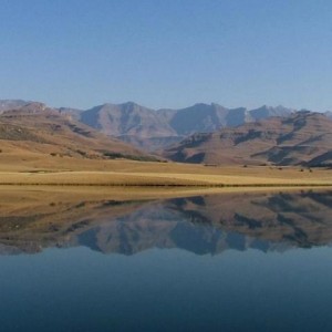 Desert mountains in background and calm lake in foreground