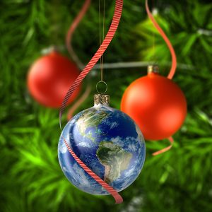 Earth ornament hanging from tree with red ribbon