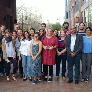 Sustainability researchers gather on brick walkway for group photo